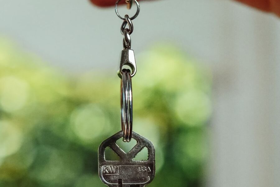 House keys held up against a blurred green background